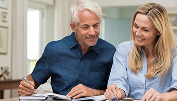 Man and woman looking at clipoboard with paperwork